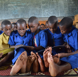 Children in Rwanda reading their first book 